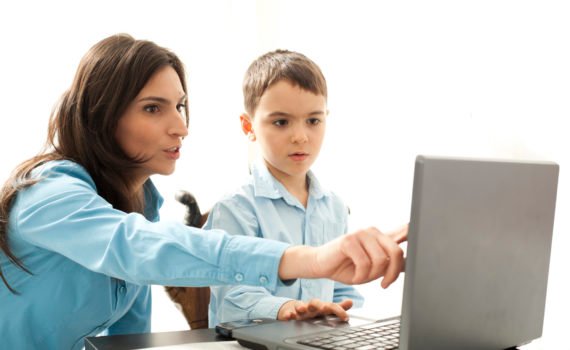 boy leaning to use computer